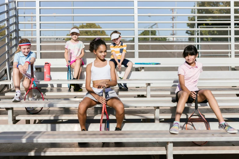 children in their school uniforms playing tennis