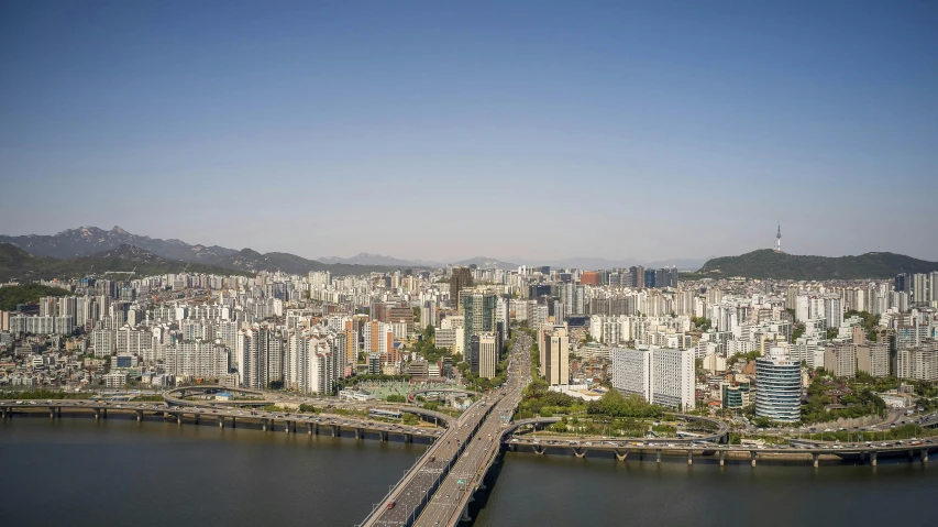 a river flowing past a large city in a valley