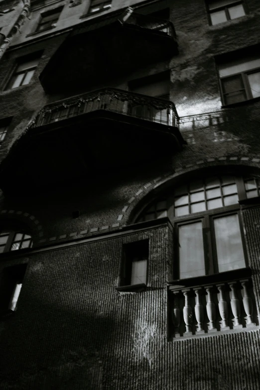 a black and white image of windows and balconies