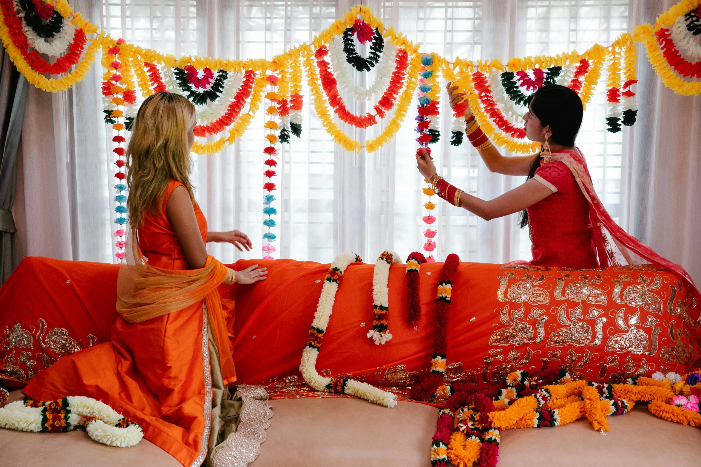 two woman decorating a stage set up for a festival