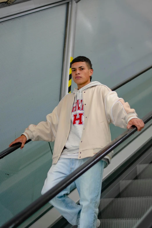 a young man is posing on an escalator