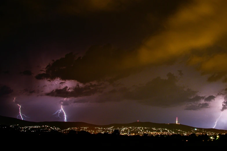 large storm with lightning strikes on night sky