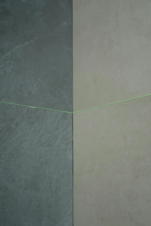 an image of two different colored walls, one with a green wire attached