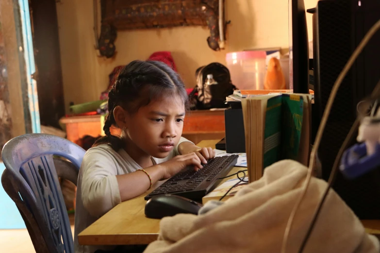a young child is on the computer looking at the screen
