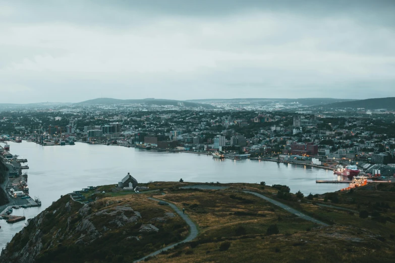 there is a city surrounded by water, a river and mountains