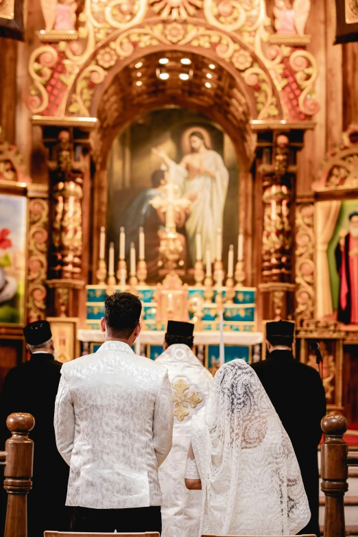 the newly married couple are sitting in front of the alter