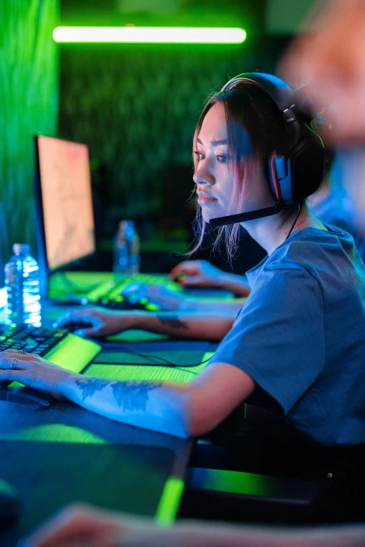 a group of people using the computer at night