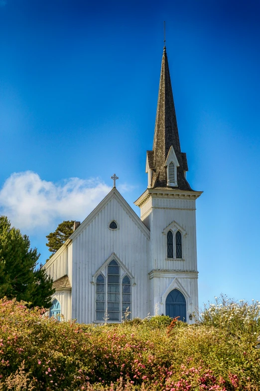 a white church sitting in a green field