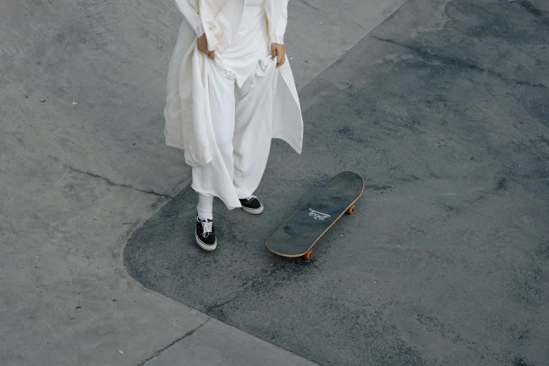a person dressed as jesus walking and holding his skateboard