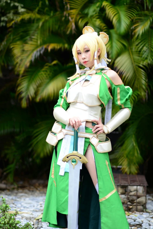 a woman is wearing a long green dress and has a sword in her hands