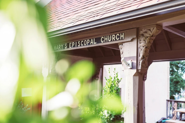 a view from the outside of a church building of an outside porch and the front door