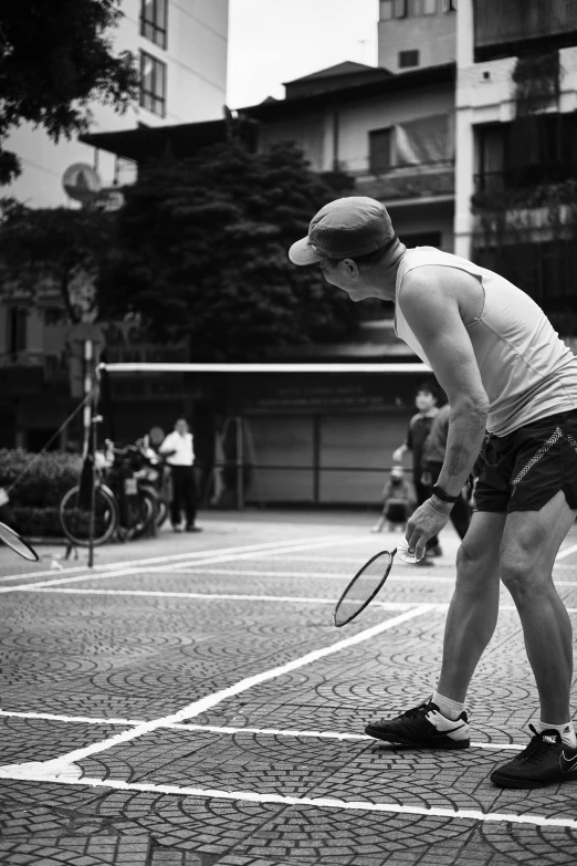 man with tennis racket on an outdoor court