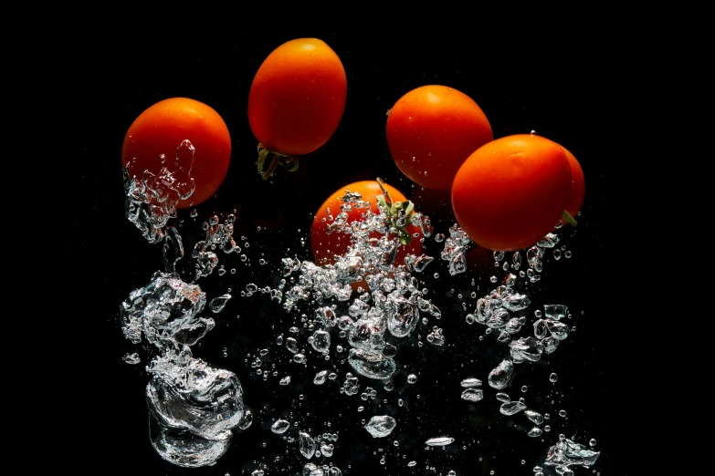 four tomatoes in the water and floating on top