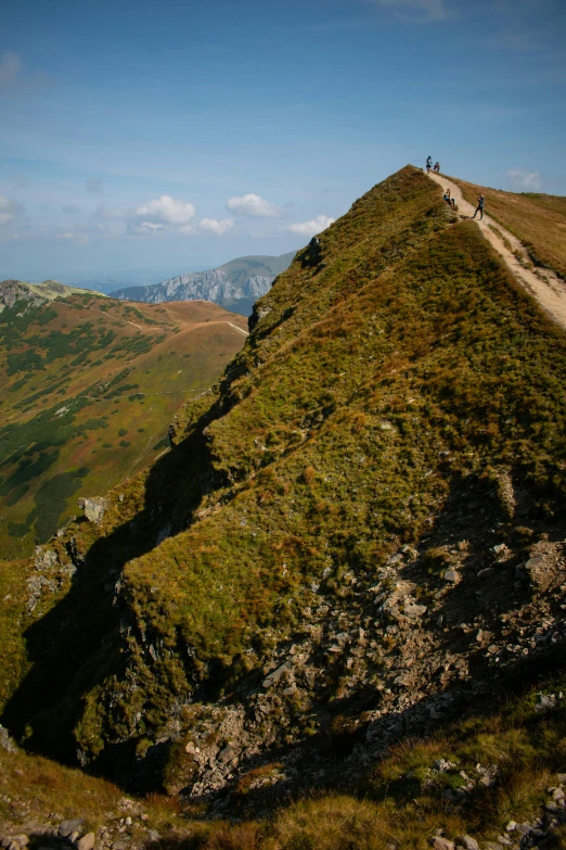 two people standing on the side of a steep hill