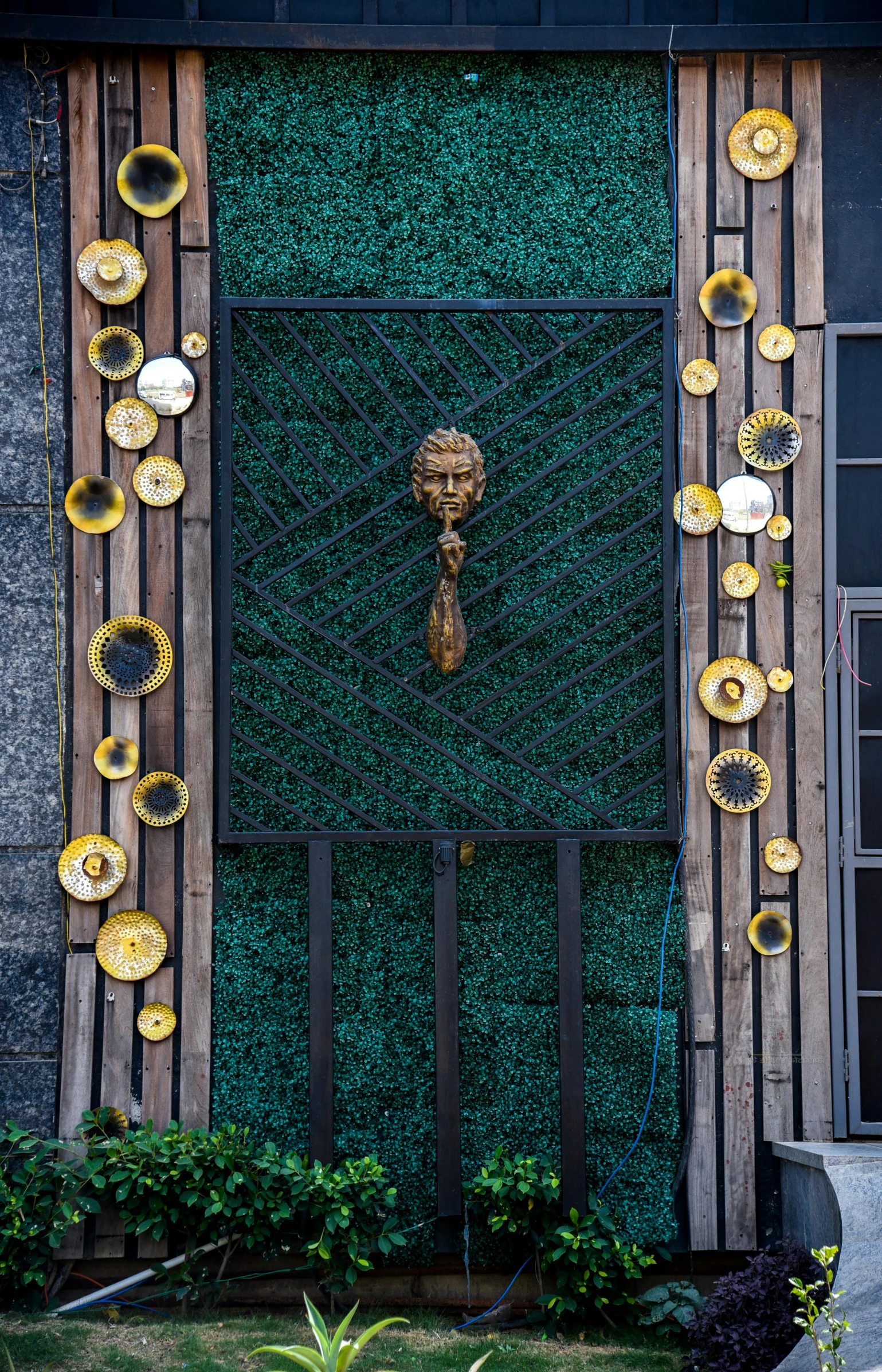 green door with golden plates hanging on it