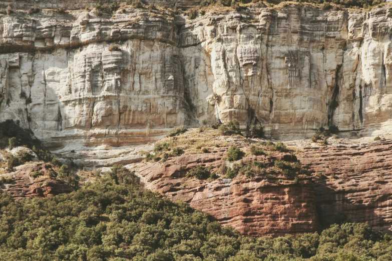 the rock formations are separated by green shrubs