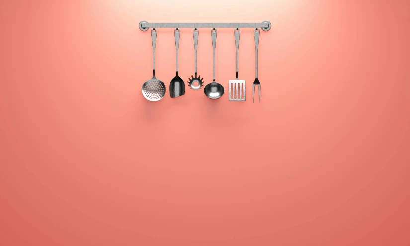 various utensils are hanging on the side of a wall