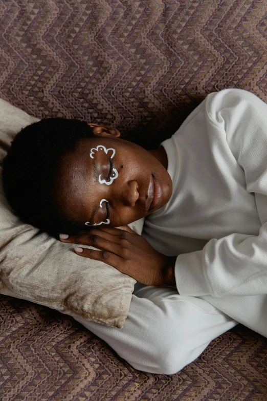 a woman lying on a bed with her head pressed up