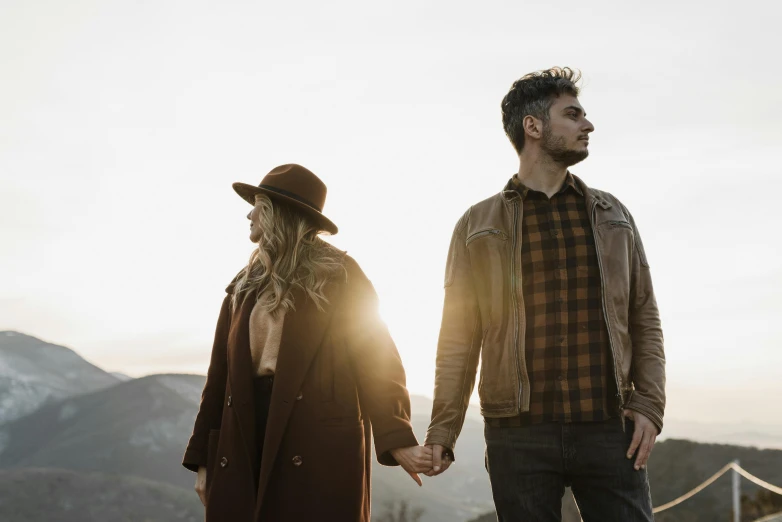 a man and a woman walking up a hill together