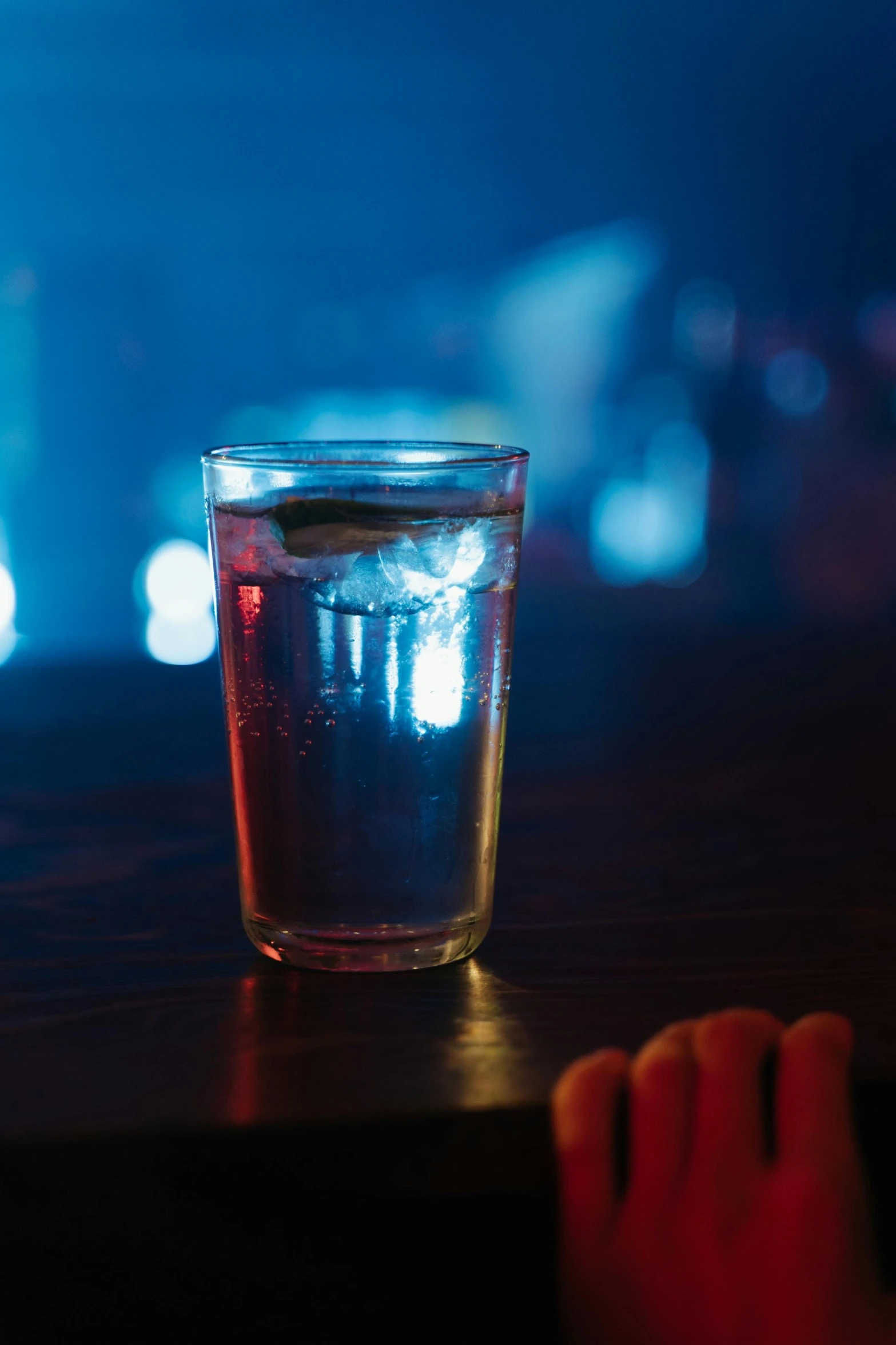 a glass filled with liquid sitting on top of a table