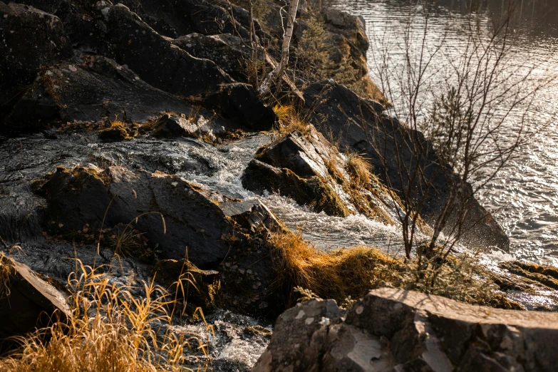 a river has lots of rocks along the water