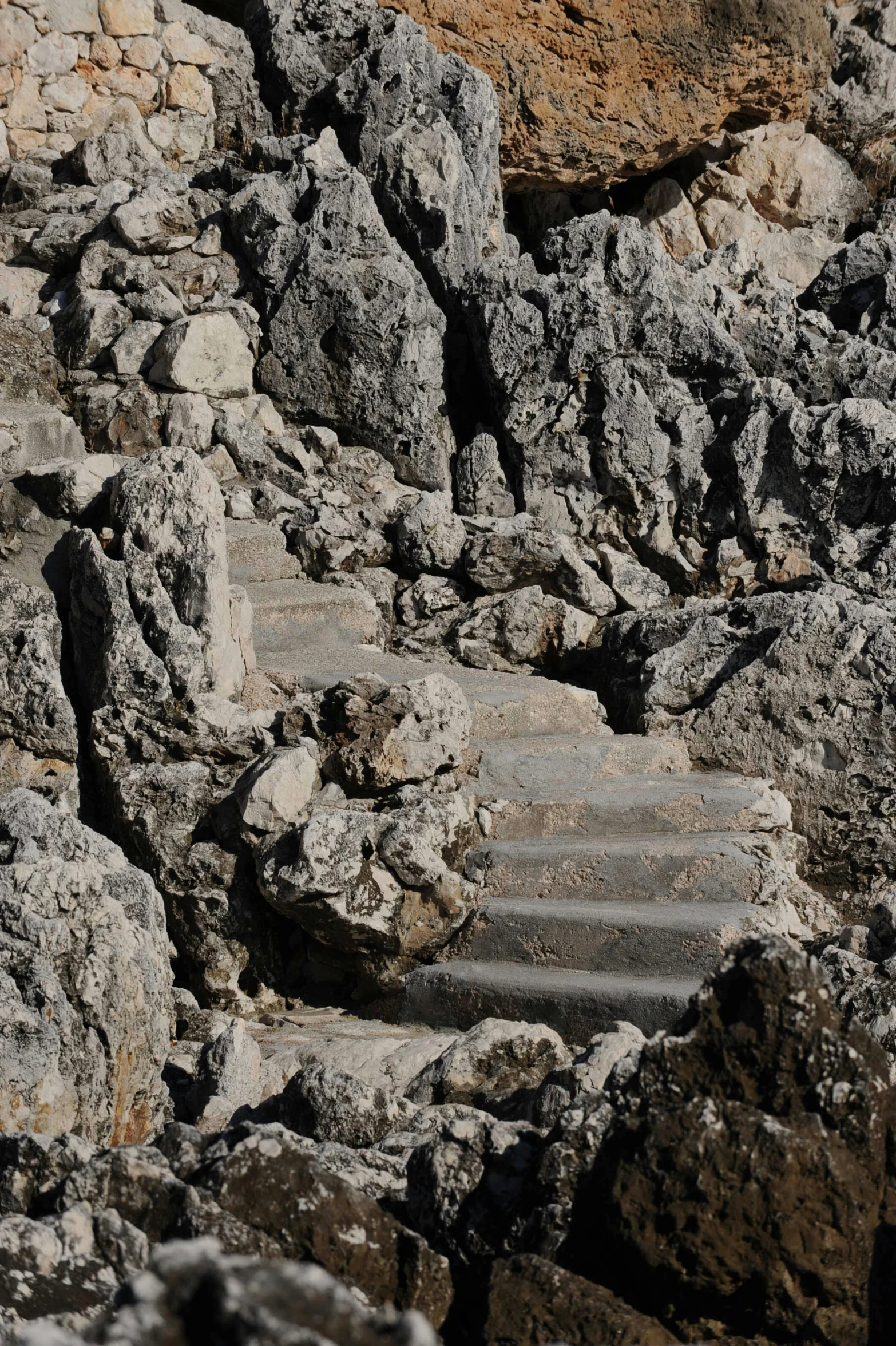 concrete steps are surrounded by rocky terrain