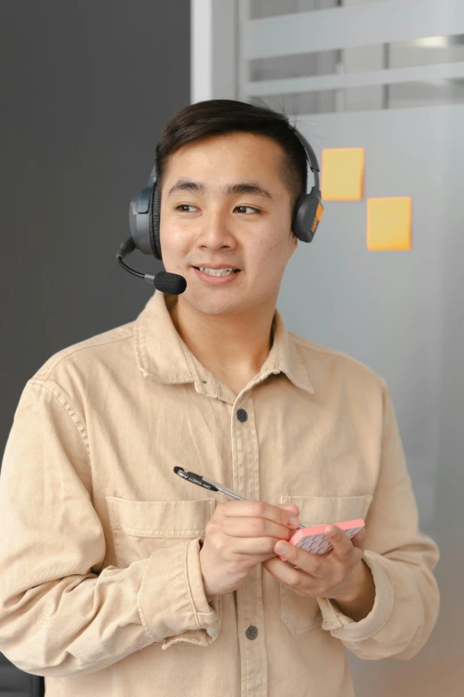 a young man wearing headphones using his mobile phone