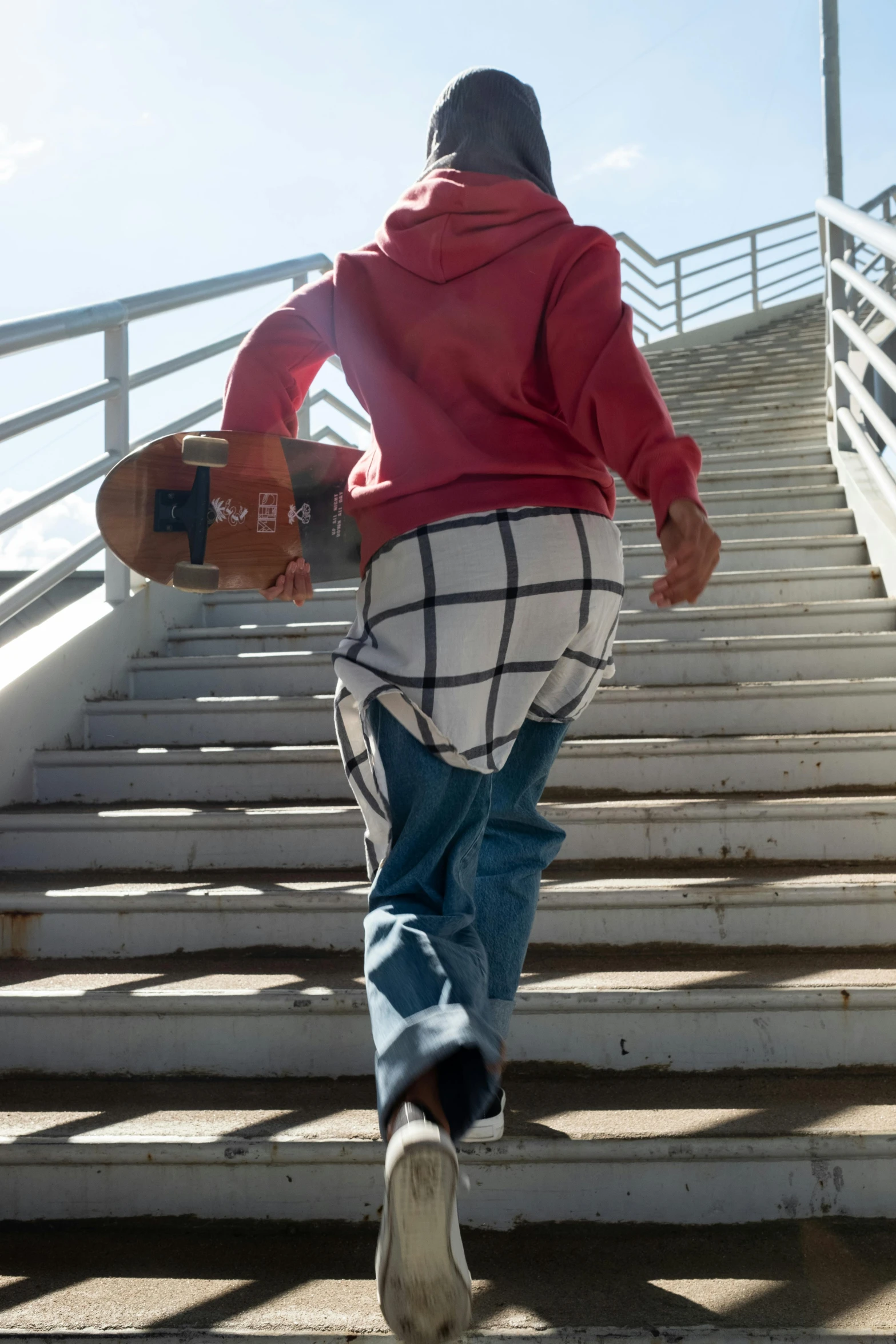 a young man with a skateboard up some steps