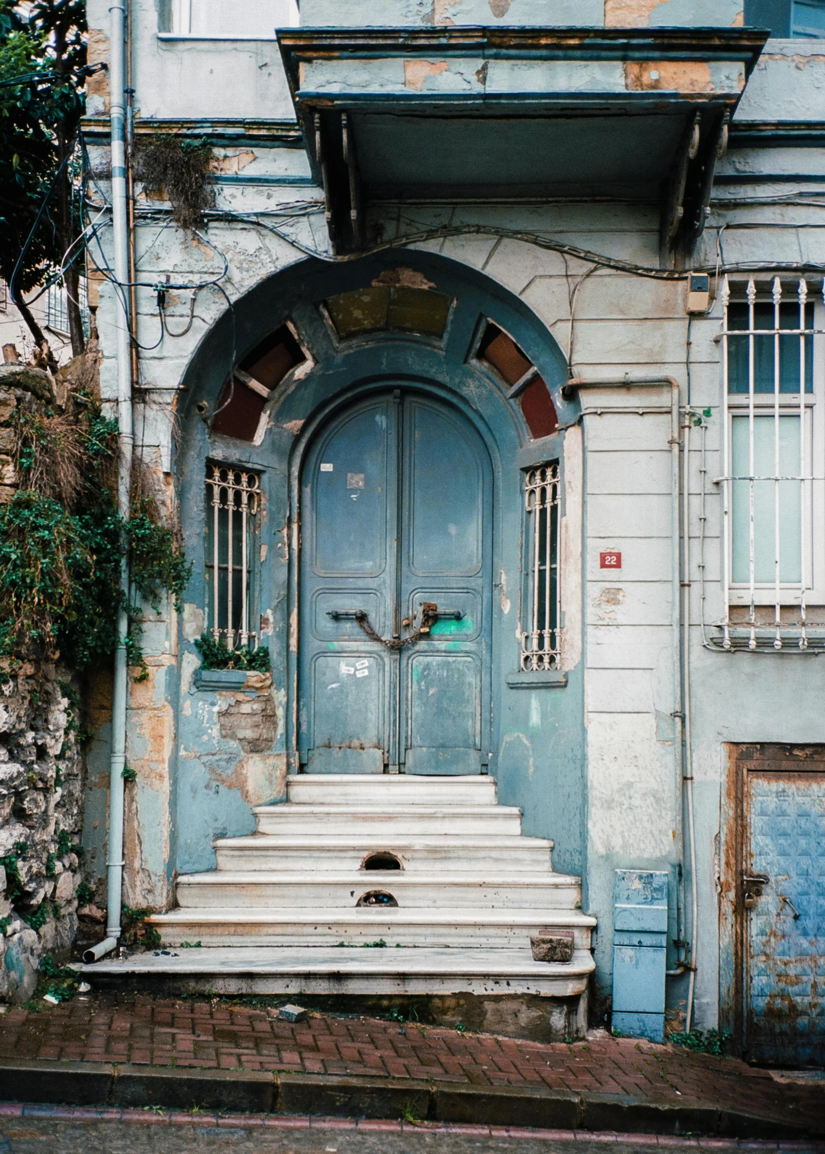 a blue doorway on the front of an old building