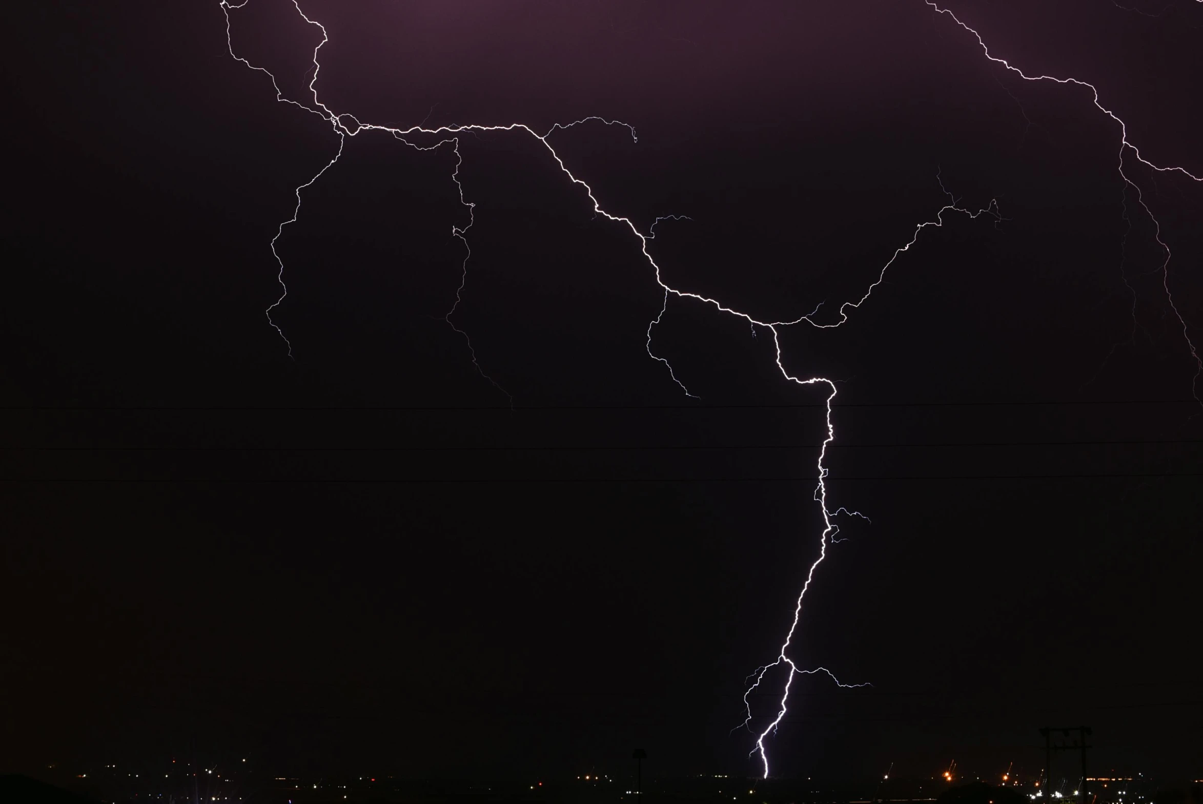 two lightning strikes can be seen in the night sky