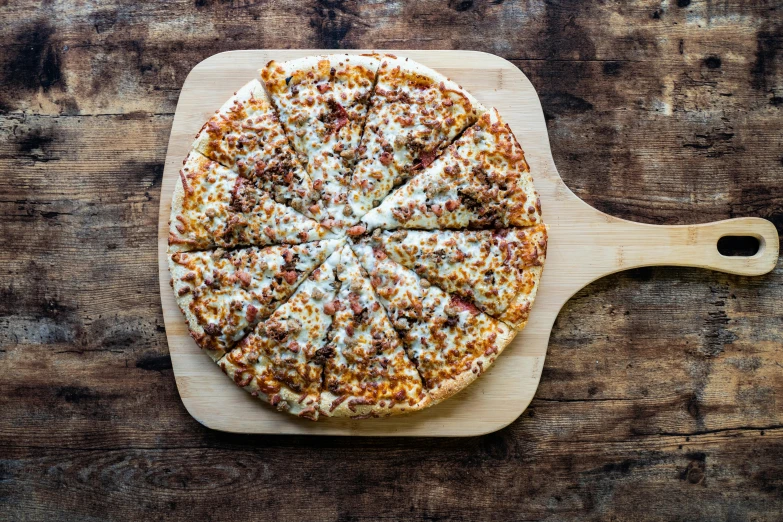 a pizza is sliced into slices on a  board