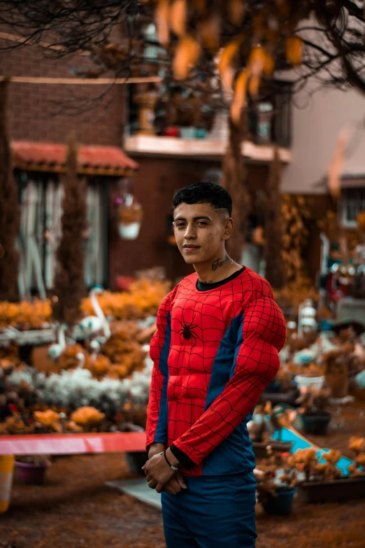 a person standing by plants and trees in the background