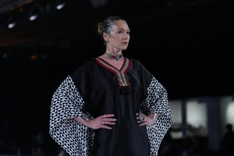 a woman standing on a runway next to a building