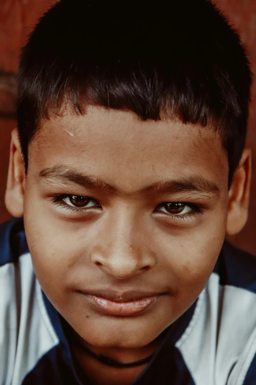 a small boy is posing for a picture