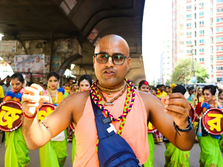 a man in a parade posing with his hands up