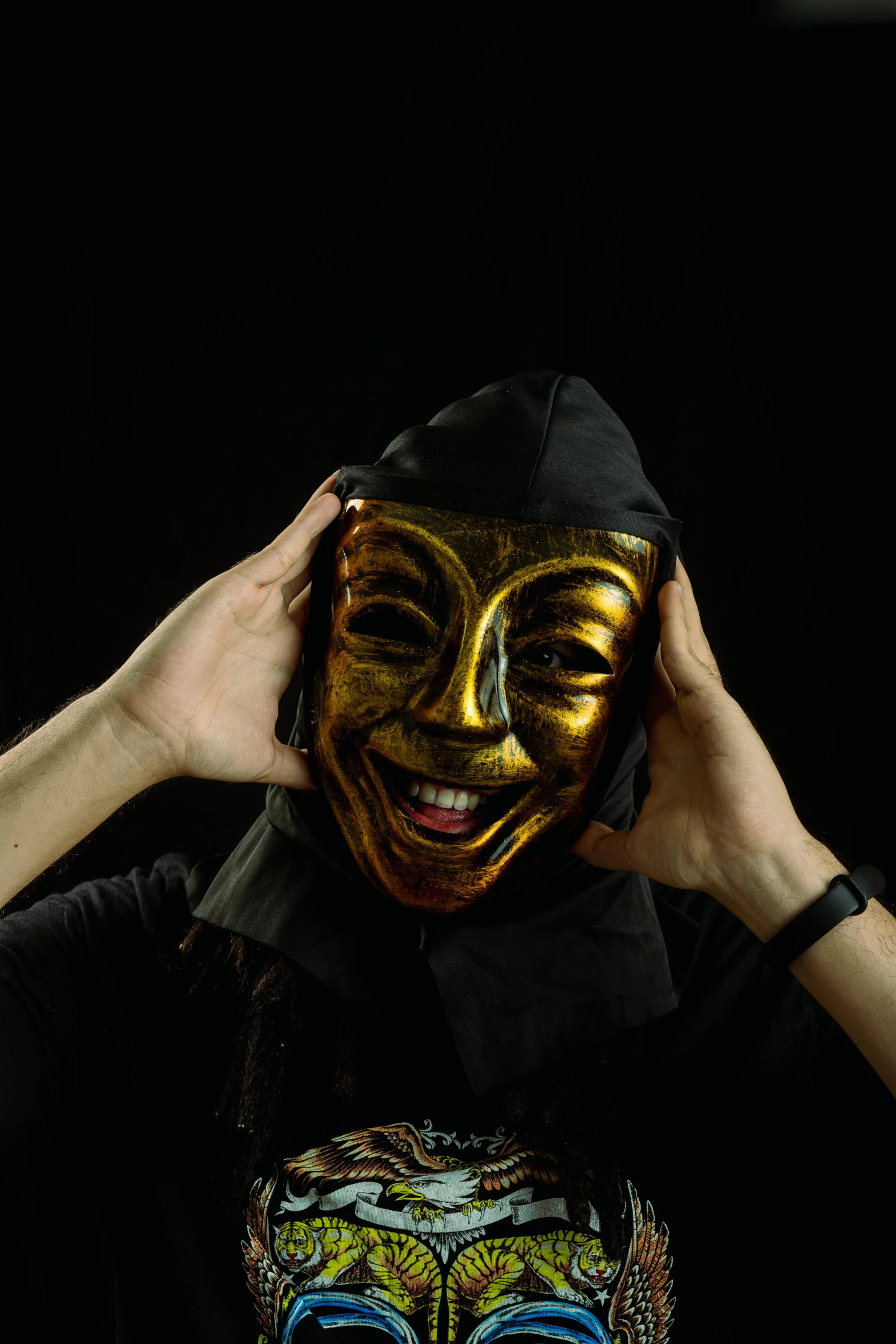 a man wearing a golden mask poses for a po