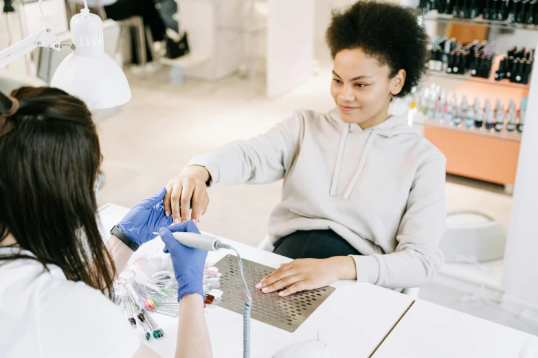 two women at an event are working on some makeup