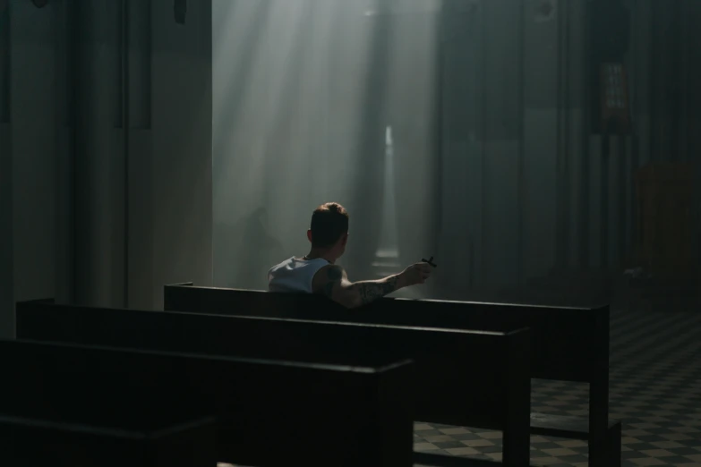 a man sits in the church and prays