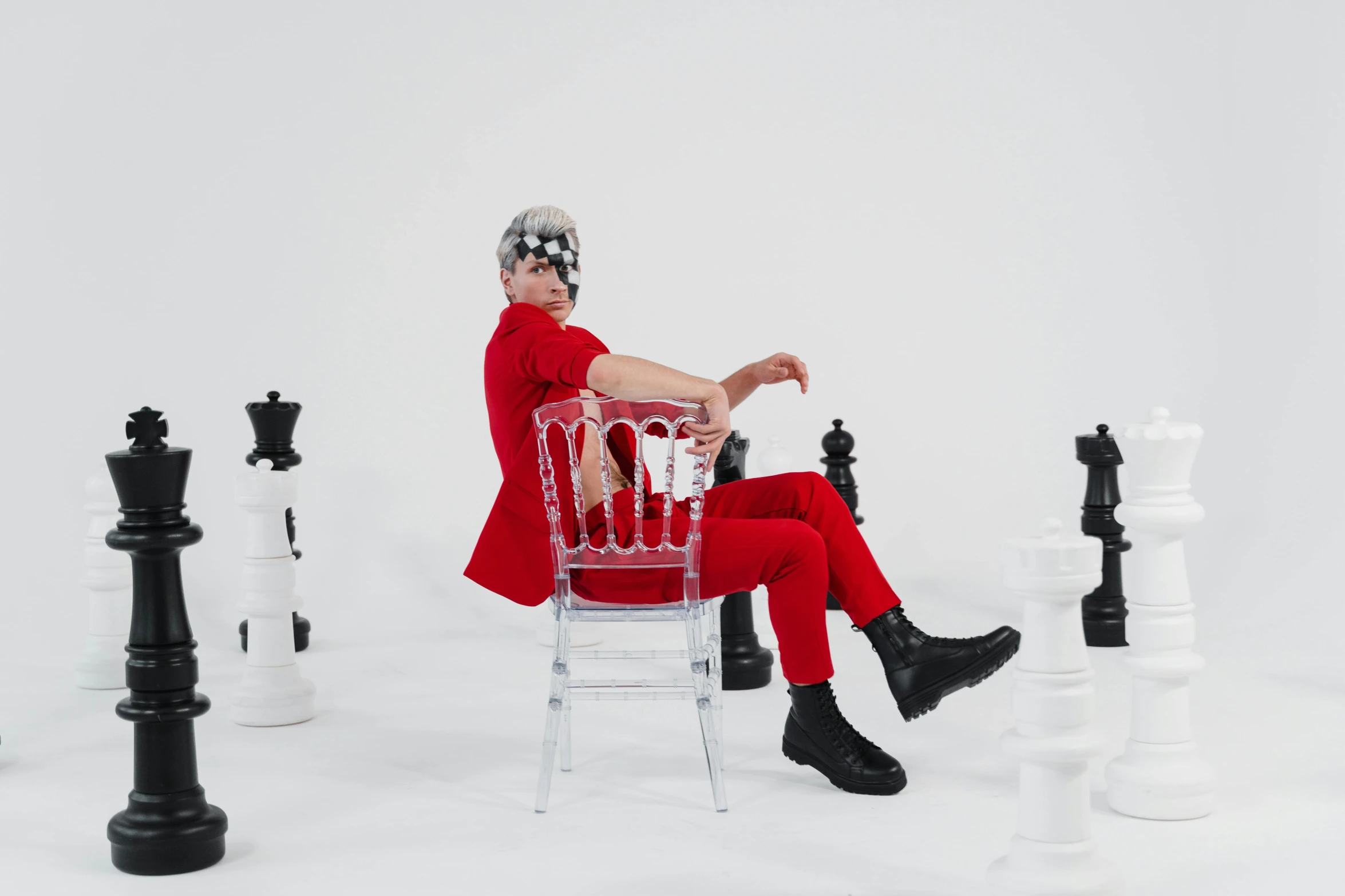 a woman in a red coat sitting on a chair