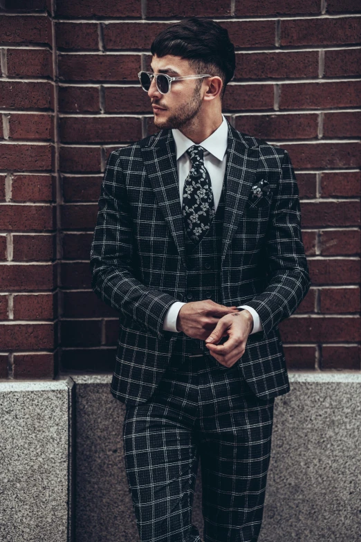 a young man in a suit posing for a po