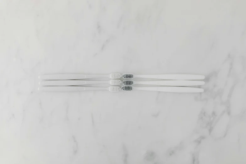 a marble surface with a pair of toothbrushes