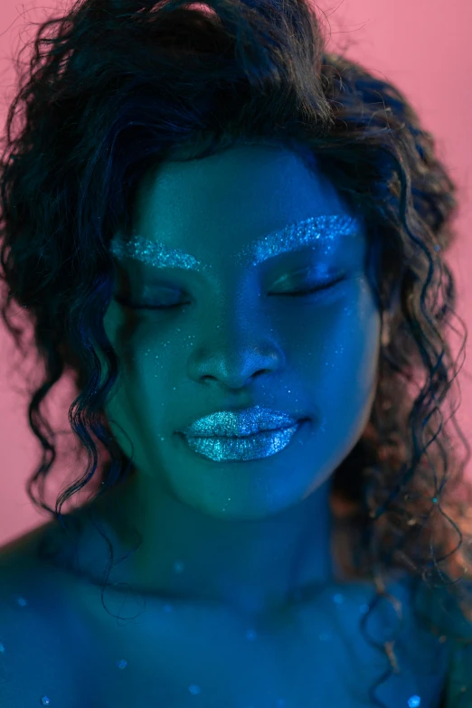 a woman with blue glitter paint on her body