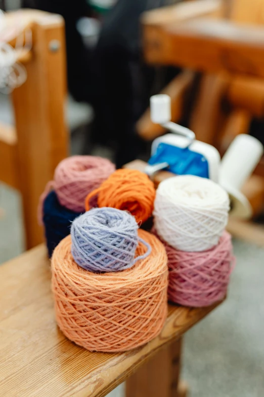 several balls of different colored yarn are on top of a table