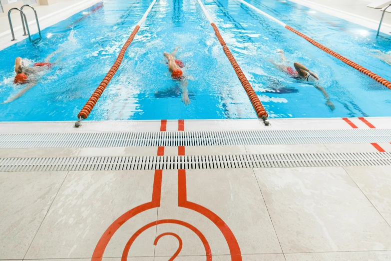 people swimming in the pool with a number mark around the end