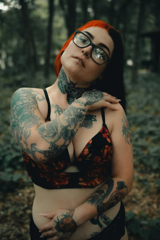 woman in black and orange  with tattoos and piercings