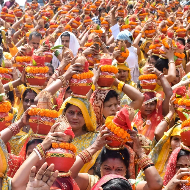 group of people with garlands and face coverings
