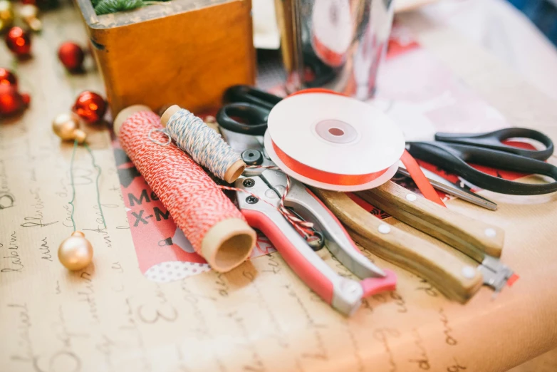 many sewing supplies and a ribbon on a table