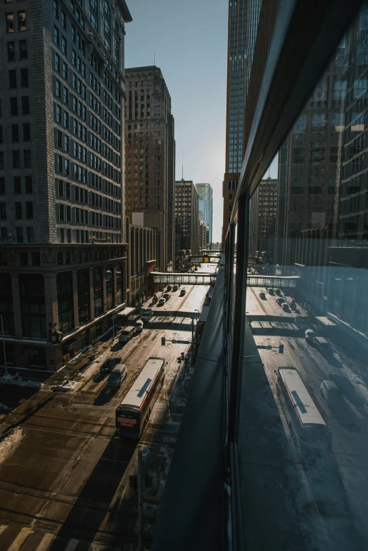 a train traveling along tracks next to tall buildings