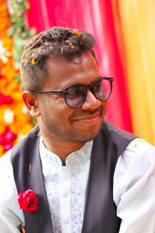 a man with a flower in his hair looks on