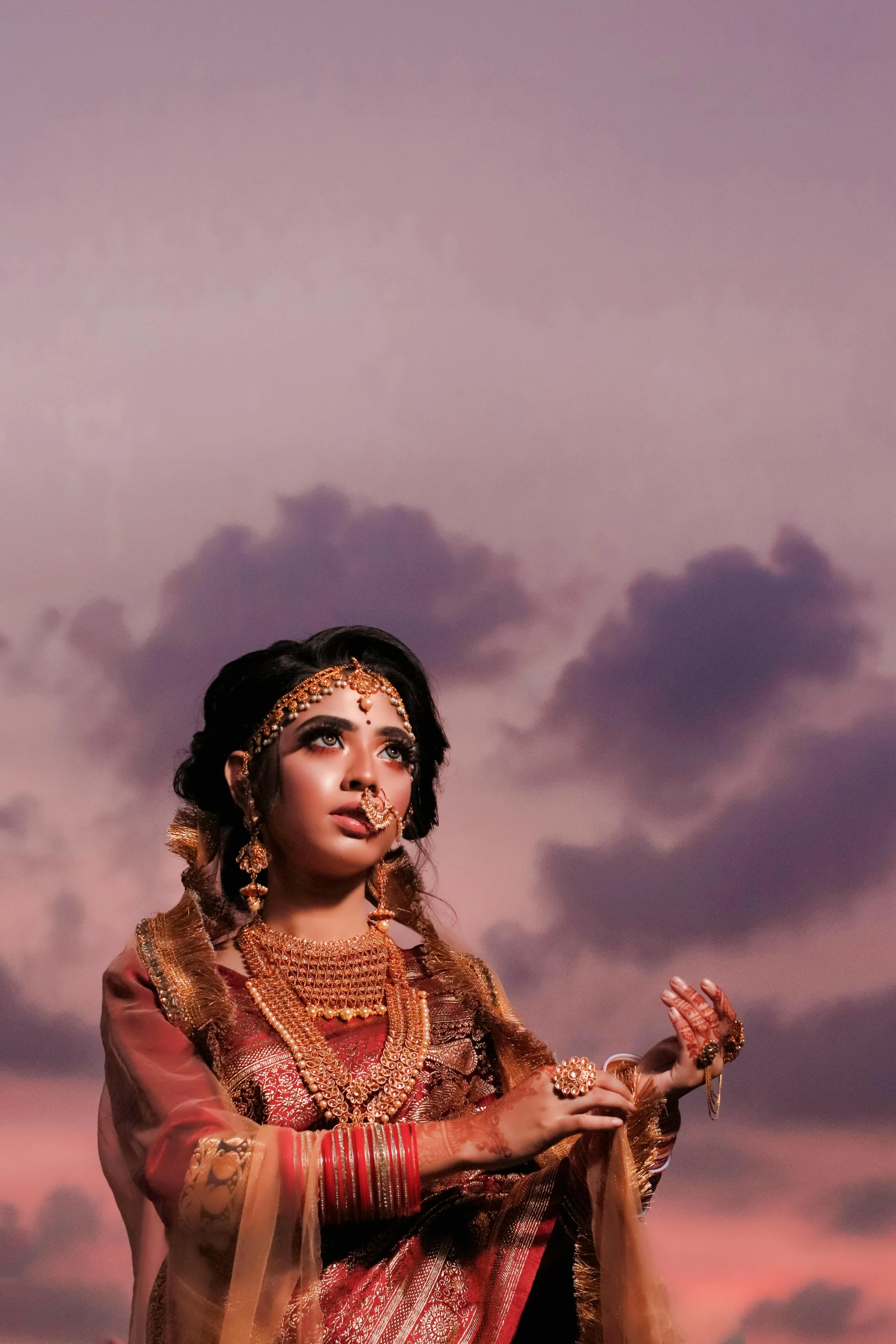 a woman dressed in traditional attire and headdress with dark clouds behind her